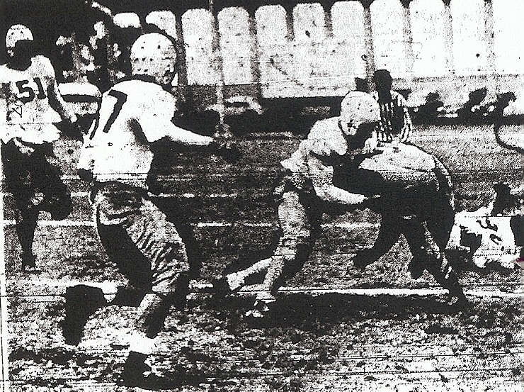 San Diego's Harry west stops Long Beach Wilson's Ray McCoy early in Cavemen's 27-13 playoff loss. Bob Conklin (51) and Cosimo Cutry (37) arrive to support. 