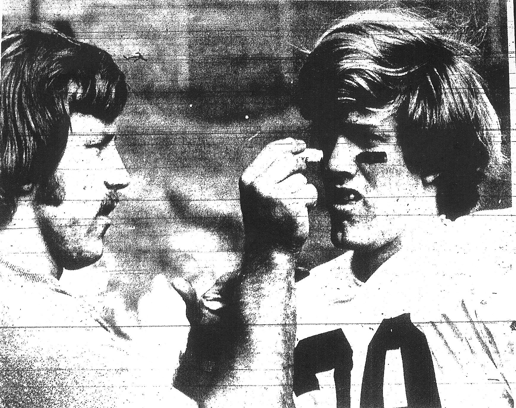 Patrick Henry assistant coach Garth DeFelice, a future NFL game officiating umpire, takes on quasi role of surgeon, removing dirt from the eye of defensive back Kirk Feldman, who just intercepted his third pass in second quarter of Patriots' 34-13 victory over St. Ajugustine.