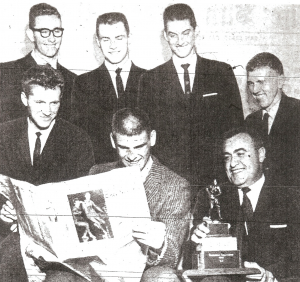 Winning Pointers, back row from left:  Larry Moore, Mike Dolphin, Dick Walden, Doug Lawrence.  Front: Winston Yetta, Don Sadas, reading newspaper account, and coach Hilbert Crosthwaite.