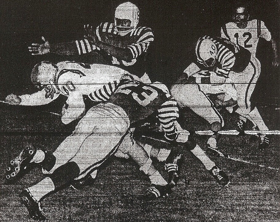 Bob Odom (23), with help from billy Bolden (top) El Capitan's Ray Homesley to a halt in Kearny's title game victory.