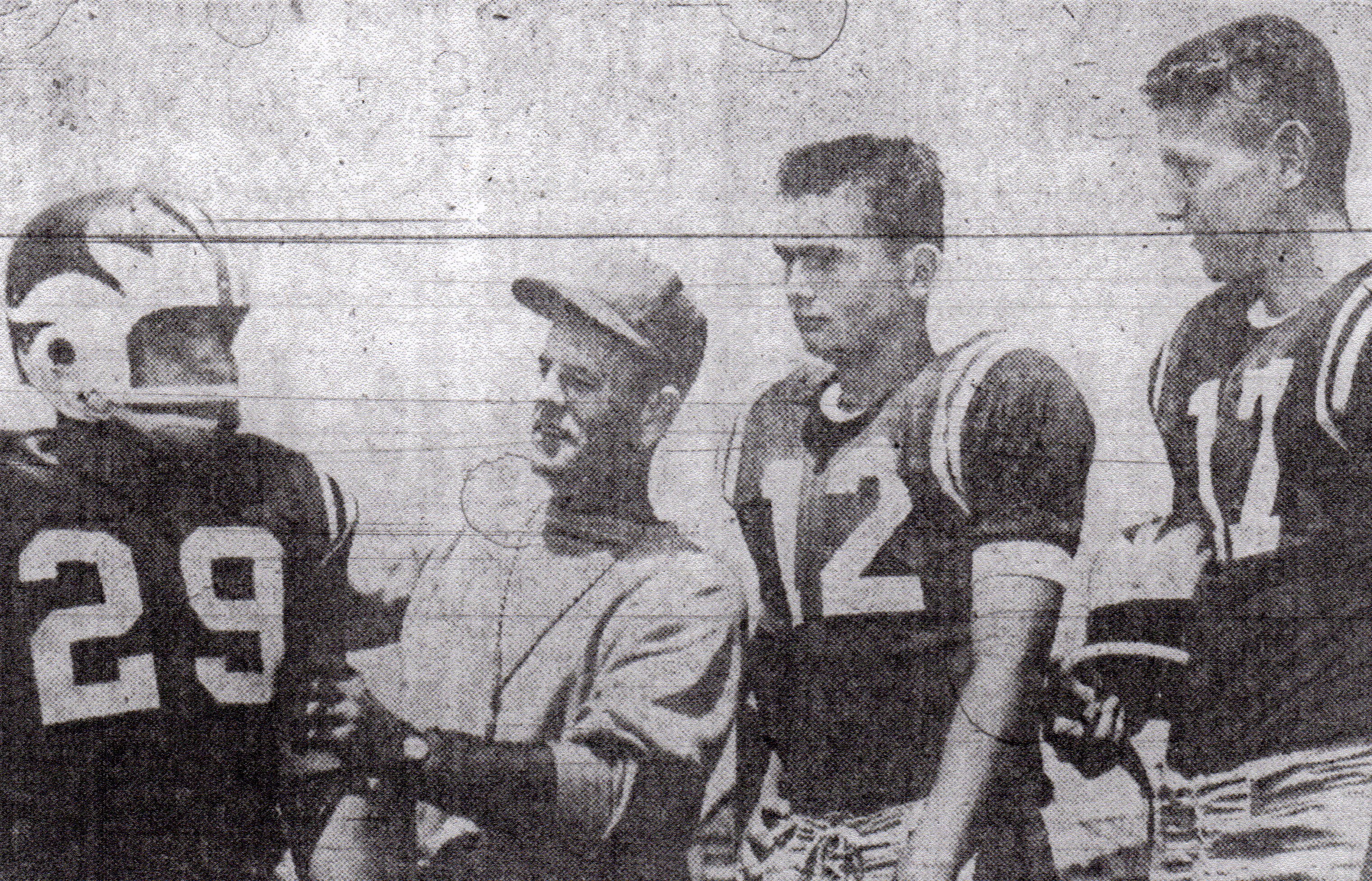 Coach Tom Parker sized up1958 season with Albert Belmontez, Leslie Pearson, and Wayne Sevier (from left).